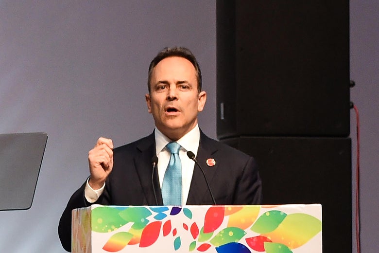 Bevin speaks at a colorful podium.